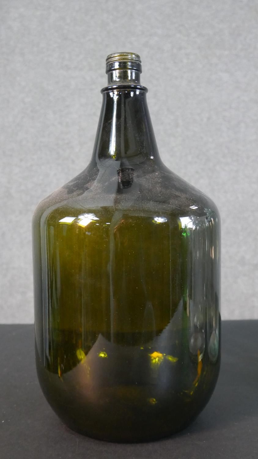 A collection of eight glass demijohns, one brown and one green glass. H.38cm (largest) - Image 3 of 4