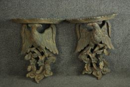 A pair of carved giltwood wall brackets in the form of eagles with foliate and floral motifs. H.50