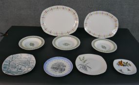 A collection of ceramic plates and platters, including two Midwinter Cherokee pattern platters,