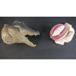 A painted fibreglass wall mounted head of an alligator plus a Indian turban hat. H.30 W.36cm (