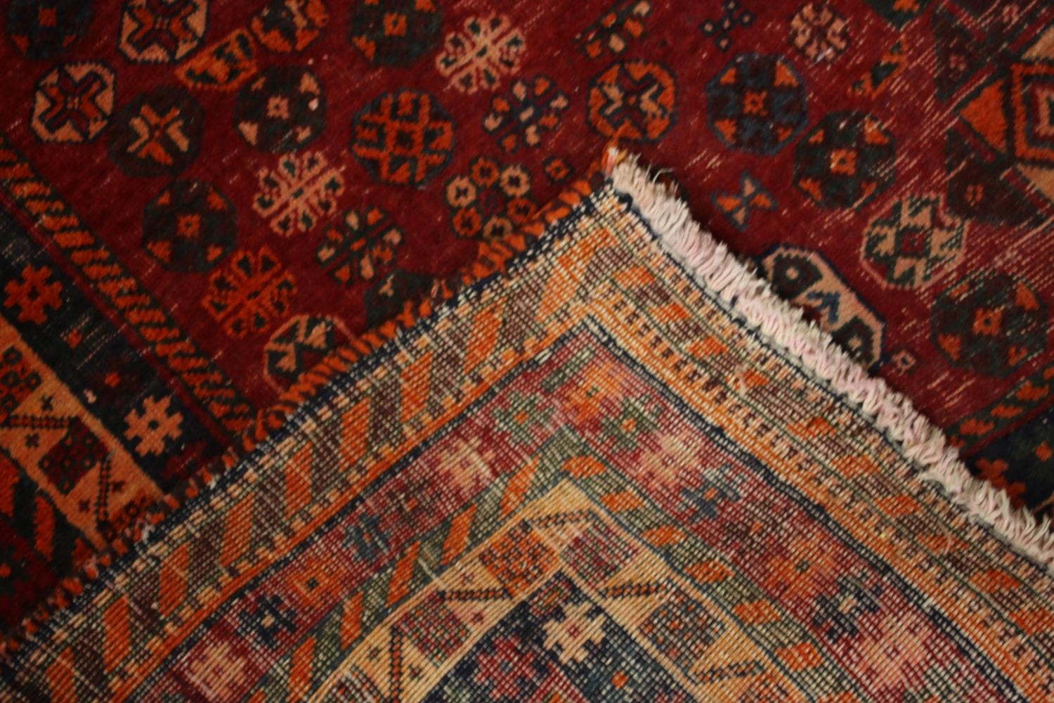 A hand made red ground Persian Qashqai carpet. L.236 W.155cm. - Image 5 of 6