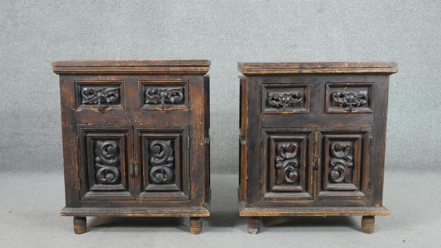 A pair of rustic stained pitch pine side cabinets, with a plank top over two short drawers and two