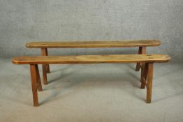 A pair of 19th century French provincial oak benches, the plank tops with rounded ends, on splayed
