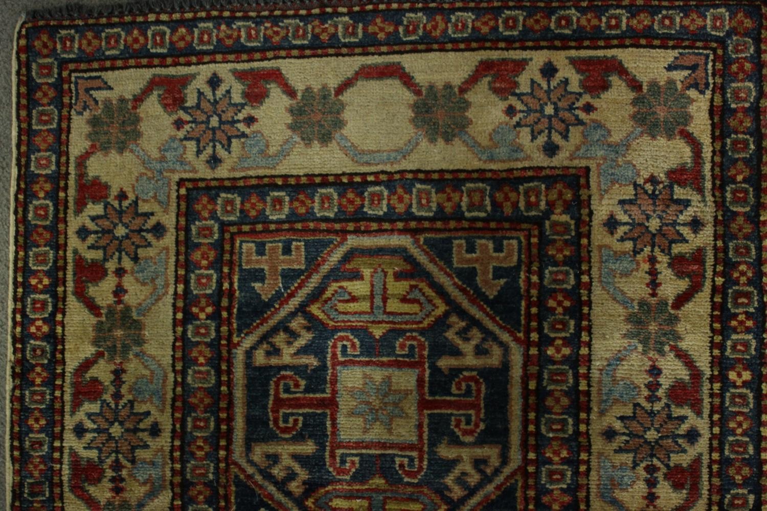 A hand made blue ground Chechen carpet. L.260 W.74cm. - Image 5 of 7