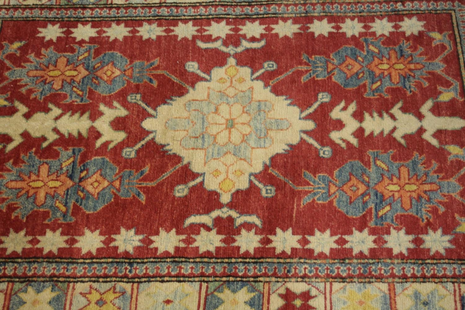 A hand made red ground Chechen Kazak rug. L.150 W.115cm. - Image 3 of 6