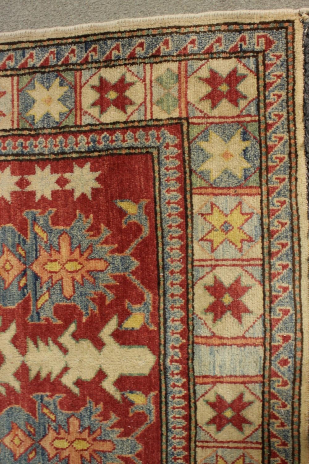 A hand made red ground Chechen Kazak rug. L.150 W.115cm. - Image 5 of 6