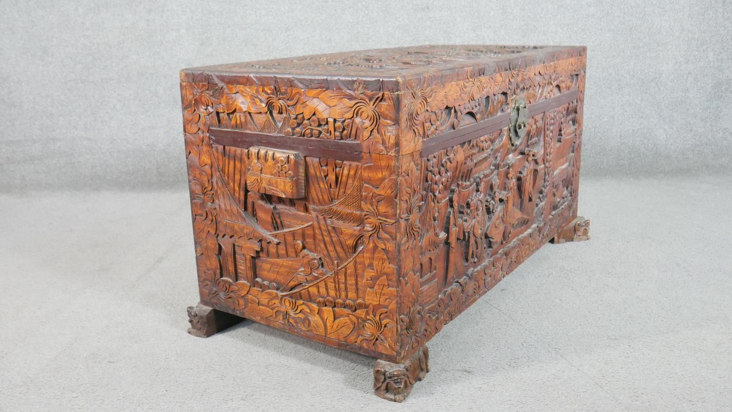 A 20th century Chinese camphorwood coffer, of rectangular form, the lid and sides ornately carved - Image 8 of 9