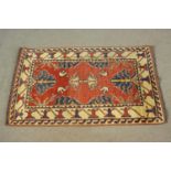 A small hand made red ground Chubi rug. L.107 W.69cm.