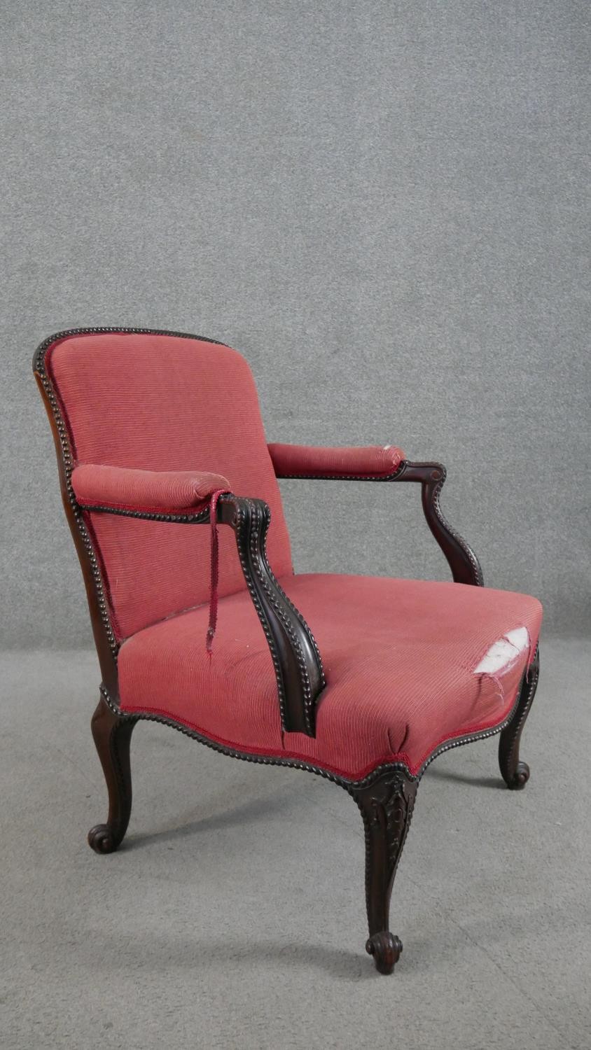 A 19th century mahogany open armchair, upholstered in crimson coloured fabric, the scrolling arms - Image 7 of 7