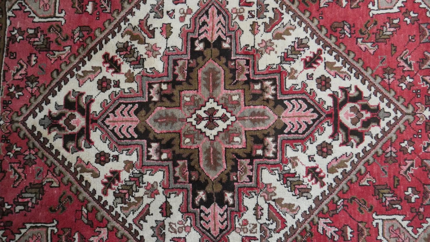 A hand made Persian Heriz carpet with central medallion on a madder field. L.201 W.158cm - Image 4 of 8