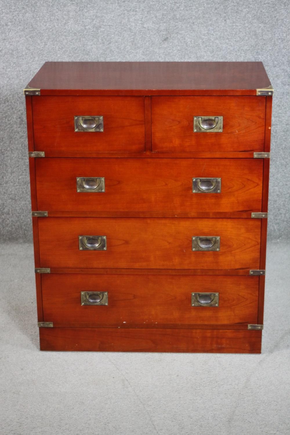 A 20th century yew wood campaign style chest of two short over three long drawers with recessed