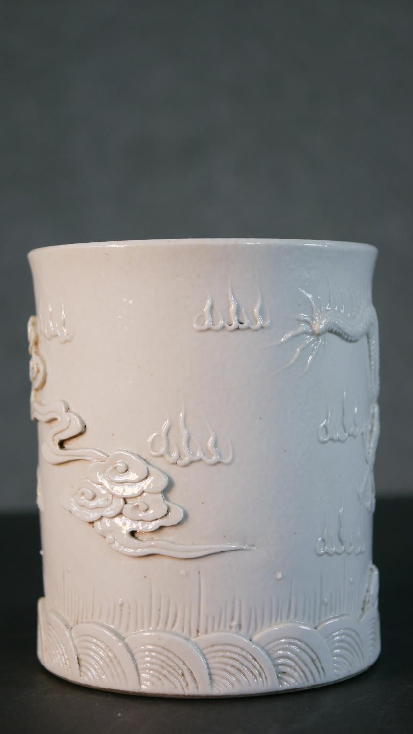 A Chinese blanc de chine relief porcelain dragon among the waves design brush pot. Impressed - Image 5 of 9