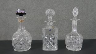 Three cut crystal decanters, including a paperweight stopper decanter and a Bridge crystal