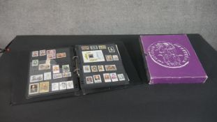 An album of world stamps along with a British Collecta coin album filled with various British coins.