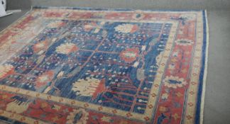 A hand made Chubi carpet with stylised palmette motifs across the pale azure field within stylised