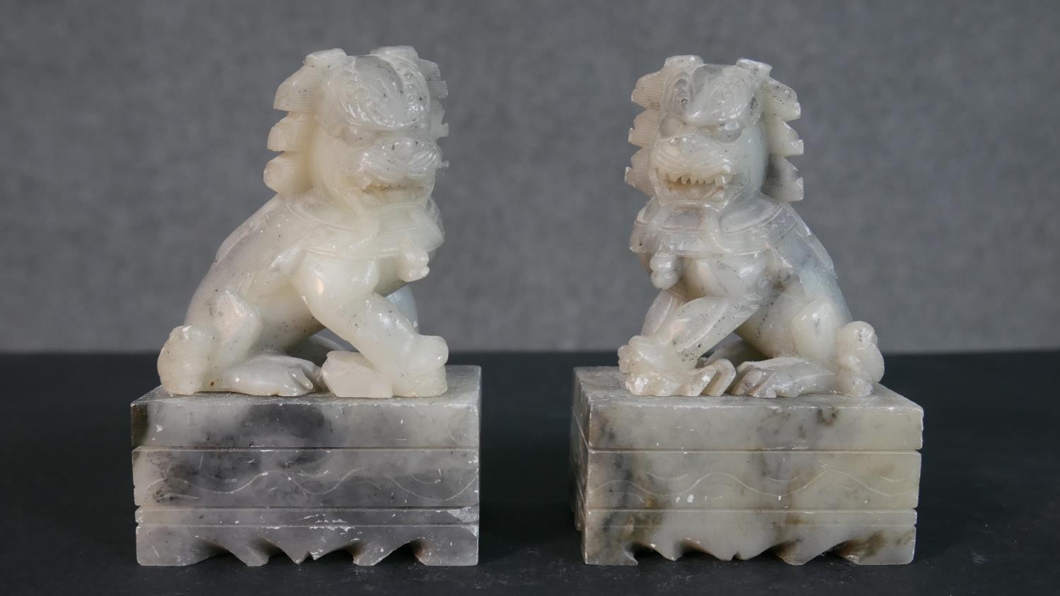 A pair of Chinese carved soapstone Foo dogs on rectangular stands along with an African stone - Image 2 of 9