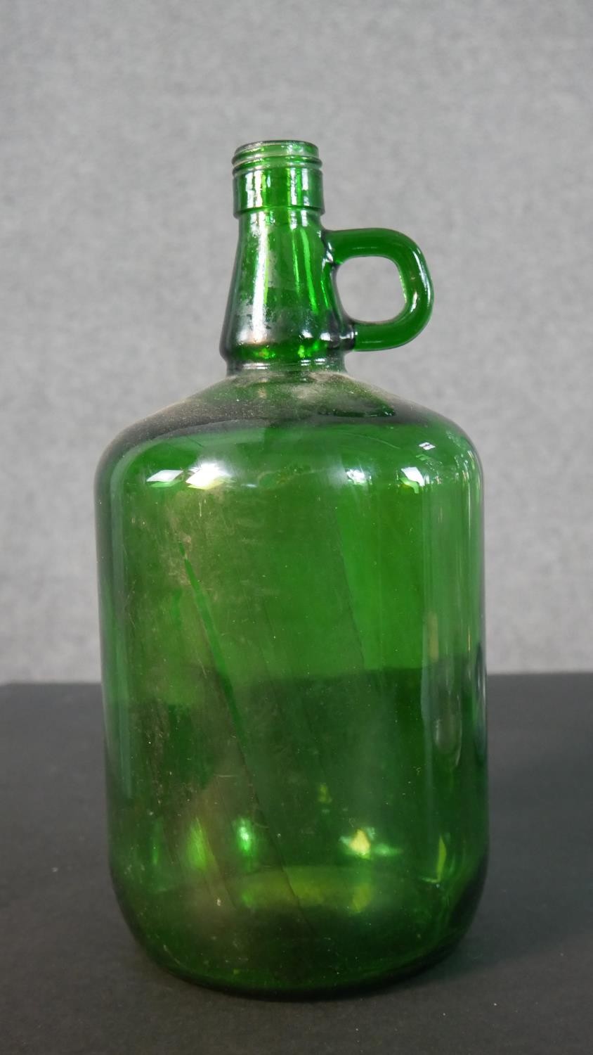 A collection of eight glass demijohns, one brown and one green glass. H.38cm (largest) - Image 2 of 4