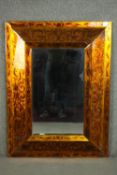 A contemporary Venetian style mirror, with a rectangular bevelled plate, the frame with a gilt