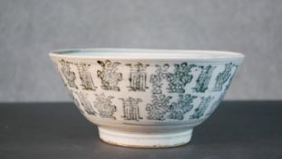 A Chinese ceramic bowl with all over character design and unglazed foot. H.11 Diam.24cm