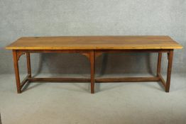 An oak refectory dining table, with a plank top, on square section chamfered legs, with brackets,