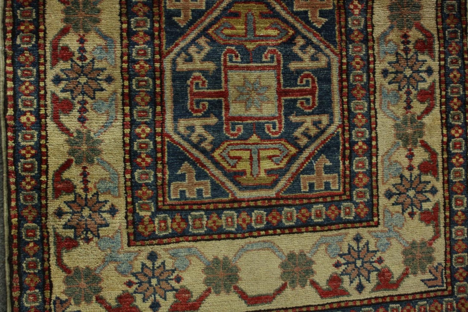 A hand made blue ground Chechen carpet. L.260 W.74cm. - Image 6 of 7