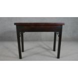 A late 18th century George III mahogany rectangular tea table, with a foldover top, the square