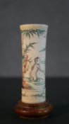 An etched and dyed Chinese bone dice cup decorated with naked figures swimming, mounted on a