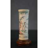 An etched and dyed Chinese bone dice cup decorated with naked figures swimming, mounted on a