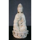 A 19th century blanc de chine porcelain Chinese figure of Guanyin sitting on a lotus base. Impressed