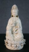 A 19th century blanc de chine porcelain Chinese figure of Guanyin sitting on a lotus base. Impressed