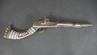 A 19th century Indian percussion musket, the butt and stock decorated with mother of pearl and