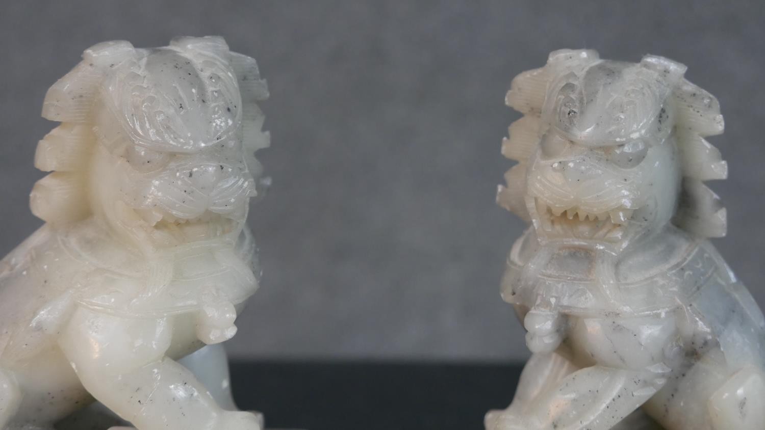 A pair of Chinese carved soapstone Foo dogs on rectangular stands along with an African stone - Image 3 of 9