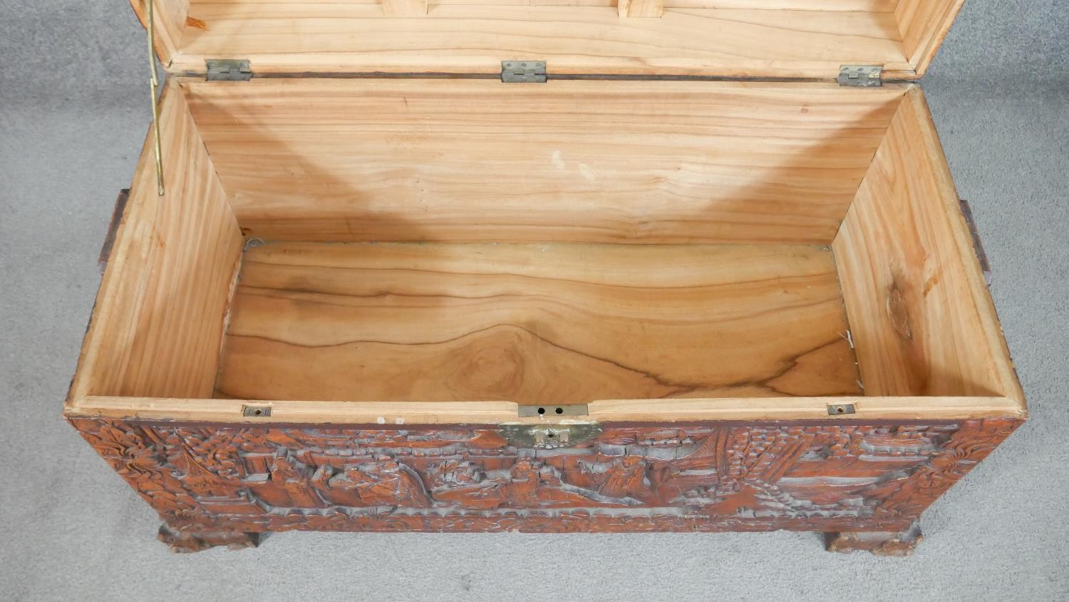 A 20th century Chinese camphorwood coffer, of rectangular form, the lid and sides ornately carved - Image 7 of 9