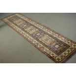 A hand made blue ground Chechen carpet. L.260 W.74cm.