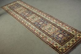 A hand made blue ground Chechen carpet. L.260 W.74cm.