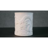 A Chinese blanc de chine relief porcelain dragon among the waves design brush pot. Impressed