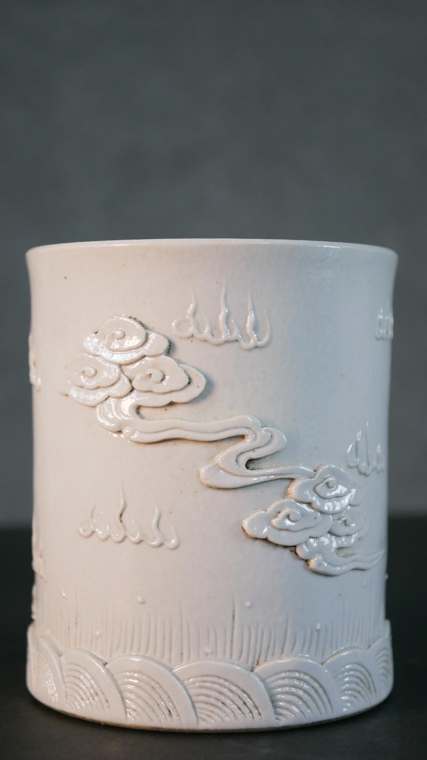 A Chinese blanc de chine relief porcelain dragon among the waves design brush pot. Impressed - Image 6 of 9