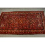 A hand made red ground Persian Qashqai carpet. L.236 W.155cm.