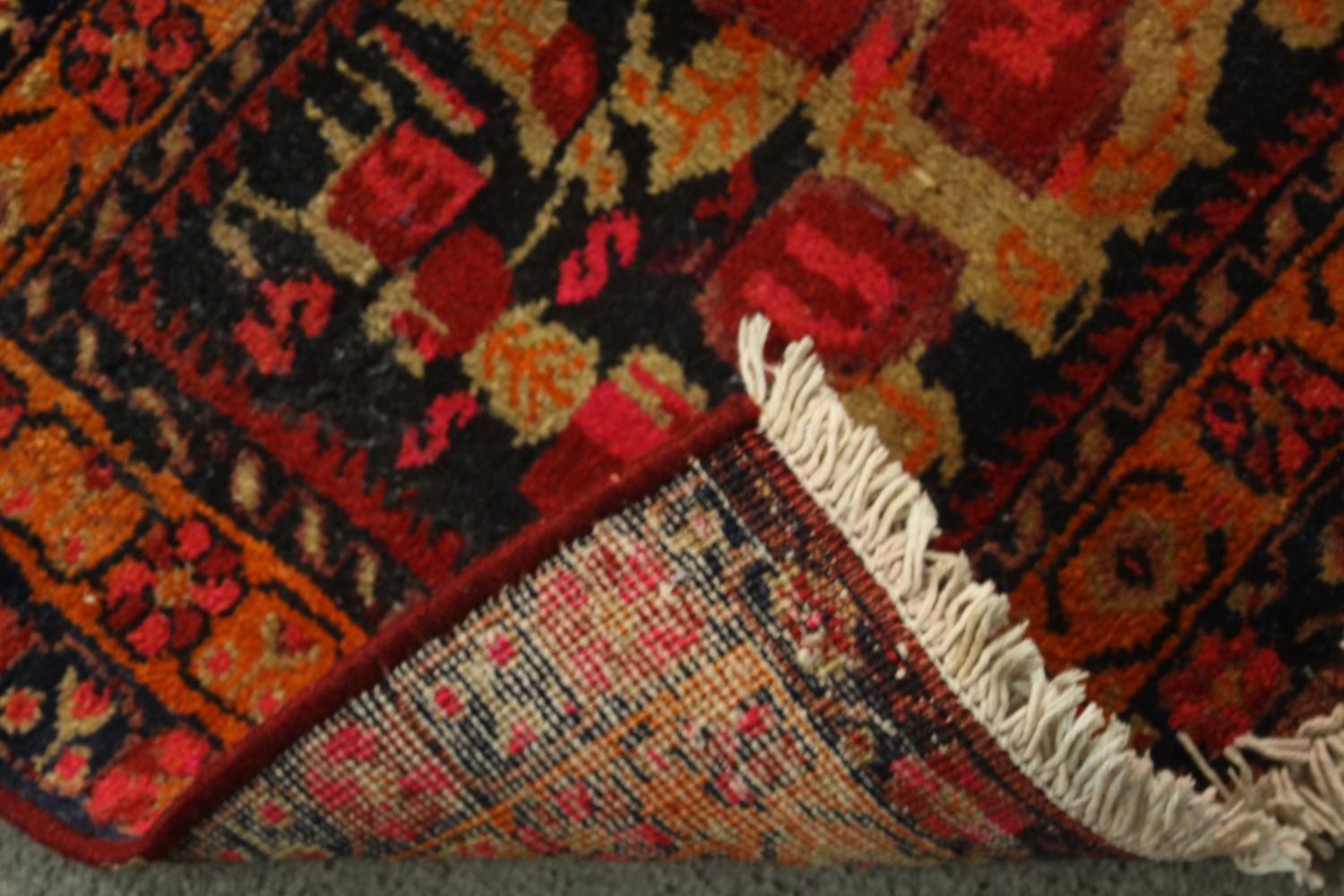A hand made red ground Persian Sirjan rug. L.68 W.50cm. - Image 3 of 3
