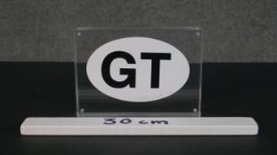 Gavin Turk, 1967, a framed signed personal monogram in perspex, dated 2007. H.12 W.17cm (largest)