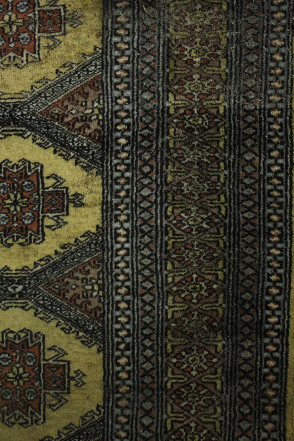 A Pakistan Bokhara rug with repeating stylised foliate motifs on a biscuit ground within multiple - Image 5 of 5