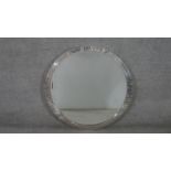 A contemporary circular wall mirror, with a bevelled mirror plate in a polished metal frame. Diam.