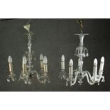 A near pair of 20th century Venetian style clear glass chandeliers, each with five scrolling