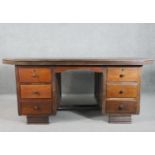 A vintage pedestal desk, the rectangular top with canted corners and a reeded edge, both pedestals