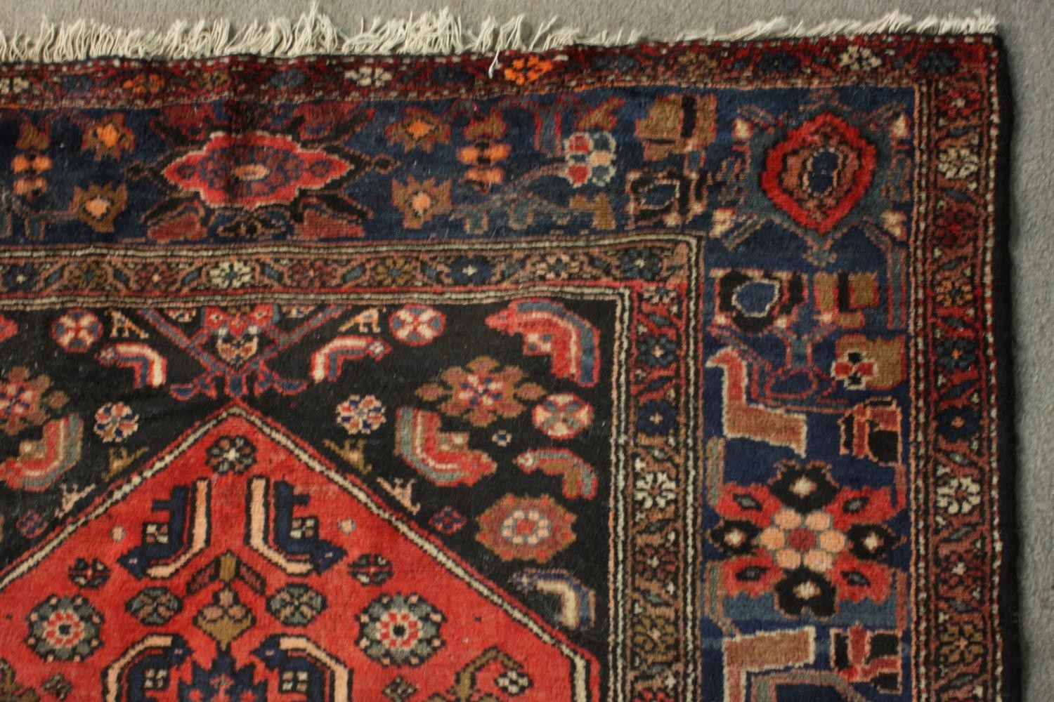 A hand made red ground Persian Hamadan carpet. L.210 W.129cm. - Image 4 of 5