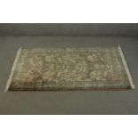 A hand made beige ground silk Kashmir Persian carpet. L.210 W.120cm.