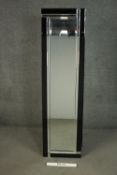 An Art Deco style frameless dressing mirror, of elongated form, with faceted mirrored and black