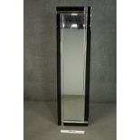 An Art Deco style frameless dressing mirror, of elongated form, with faceted mirrored and black