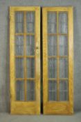 A pair of vintage simulated oak doors, lead set with textured glass panels. H.200 W.57cm. (each)