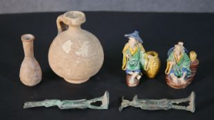 A collection of curiosities, including two Roman style ceramic vessels, two Egyptian style bronze